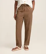 Pantalón marrón de cintura alta y corte recto cropped, confeccionado en sarga de viscosa. Cuenta con cintura elástica ajustable con lazo, bolsillos delanteros y diseño liso.