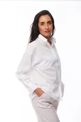 Camisa blanca de algodón con cuello clásico, manga larga y bolsillo en el pecho.