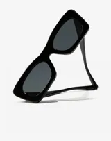 Gafas de sol Hawkers unisex, modelo Lauper, con montura cuadrada de acetato color negro y lentes grises.