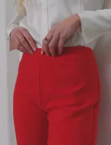 Pantalón sastrero de corte slim, color blanco, con pretina anatómica y panel interno modelador. Presenta bolsillos laterales tipo ojal, bolsillos traseros simulados y nervadura vertical marcada en el frente.