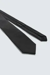 Corbata ancha de color negro, confeccionada en tejido de seda.