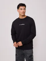 Sweater negro de corte regular con logo Rusty estampado en el pecho.