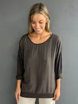 Blusa marrón de diseño holgado, con escote redondo y mangas largas. Confeccionada en la parte delantera con viscosa y algodón, y en la trasera y mangas con una mezcla de algodón, viscosa y lycra.