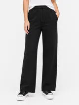 Pantalón de jogging negro, tiro medio, corte ancho y recto, con cintura elástica y cordón ajustable.