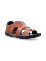 Sandalias de cuero color tostado con diseño de tiras cruzadas y cierre de velcro en el lateral, con suela de goma negra y plantilla marrón oscura.