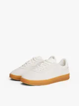 Zapatillas de corte bajo Tommy Hilfiger de inspiración retro, confeccionadas en ante color blanco con suela de goma color caramelo. Presentan monograma TH tonal en el lateral, detalles de ventilación en la puntera y cierre con cordones.