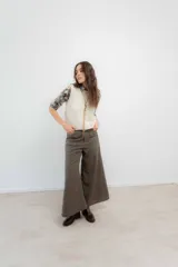 Pantalón de corte wide leg en color azul marino, con tiro medio-alto y cierre frontal con botón metálico decorativo.