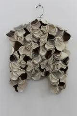 Chaleco negro con apliques circulares de lana merino afieltrada, teñida artesanalmente.