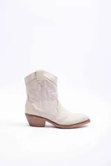 Bota texana color beige, con taco cuadrado de madera, punta fina y costuras decorativas estilo western en la caña.