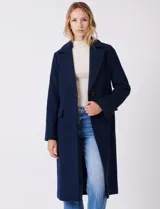 Tapado largo de lana Michael Kors, de corte recto y silueta estructurada. Presenta cuello con solapas amplias, cierre frontal con botones y bolsillos laterales con tapa. Incluye forro interno a tono.