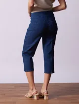 Pantalón capri blanco de algodón denim con pretina ancha elastizada, bolsillos delanteros simulados y bolsillos traseros aplicados.