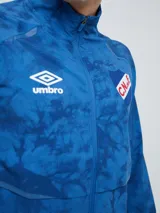 Campera deportiva Umbro del Club Nacional de Football, modelo Grok, en color bordó con diseño estampado sutil. Cuenta con cierre frontal completo, cuello alto y bolsillos laterales.