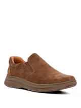 Zapatos slip-on Hush Puppies modelo Hunt II de color marrón, con capellada de cuero, suela ultraliviana y flexible con tecnología Zero G y paneles elásticos laterales para un calce cómodo.
