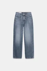 Jeans de mujer, tiro alto, color azul medio con efecto desgastado (lavado claro en muslos y oscuro en bordes). Corte recto y ancho (mom fit) con cinco bolsillos y cierre frontal de botón y cremallera.