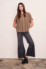 Blusa color beige con estampado animal print en marrón, de corte holgado y mangas cortas.