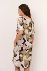 Vestido midi de lino con estampado floral en tonos beige, marrón y violeta, de corte recto y mangas cortas.