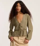 Blusa tipo bata de algodón color verde oliva, con escote en V, cierre frontal mediante lazos, mangas largas y detalles de bordados florales y encaje en el frente.