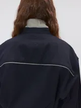 Camisa de estilo western confeccionada en algodón grueso color negro. Presenta detalles de costuras decorativas en tonos claros en el pecho y a lo largo de la cartera de botones. Posee cuello clásico, cierre frontal con botones y un calce holgado.