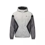 Campera rompevientos con capucha Nike Jordan, diseño color block en tonos gris claro, gris oscuro y negro. Presenta cierre frontal completo, bolsillos laterales y logo Jumpman bordado en el pecho.