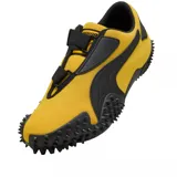 Championes Puma modelo Mostro OG Prime, color amarillo con detalles en negro. Presentan un diseño distintivo con suela de goma con relieve de tachones, cierre de velcro y la icónica franja lateral de la marca.