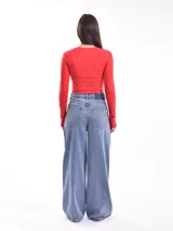 Remera de manga larga color gris oscuro, ajustada al cuerpo, con un estampado frontal de flores y texto en color blanco.