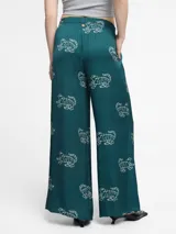 Pantalón palazzo negro con estampado de tigres rosas, cintura elástica y bolsillos laterales.