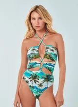 Traje de baño enterizo con estampado de palmeras y motivos playeros, con tiras finas cruzadas en el frente y espalda descubierta.