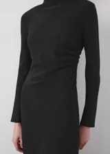Vestido midi negro de manga larga, con cuello alto drapeado y corte estructurado en la cintura, falda acampanada de caída suave.