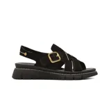 Sandalias planas de gamuza negra con tiras cruzadas, suela track y hebilla metálica dorada lateral.