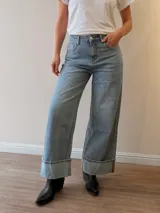 Pantalón de jean wide leg, tiro medio-alto, color celeste con lavado vintage, corte amplio y dobladillo ancho fijo en los tobillos.