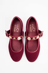 Ballerinas de gamuza color bordó con tira ajustable en el empeine, decorada con apliques metálicos dorados y hebilla lateral.