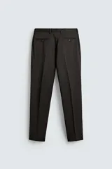 Pantalón de traje regular fit confeccionado en tejido de lana. Presenta bolsillos frontales, bolsillos traseros de vivo con botón y cierre frontal con cremallera y botón.