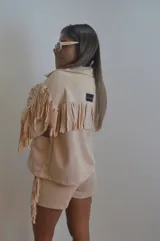 Campera color beige de gamuza sintética con flecos en mangas, espalda y ruedo.