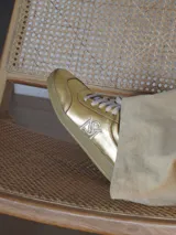 Championes de gamuza en combinación de colores gris, naranja y fucsia, con cordones beige y suela de goma.