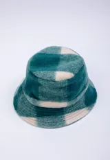 Gorro tipo bucket de textura peluda, con estampado a cuadros en tonos azules y beige.
