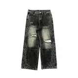 Pantalón de jean estilo baggy, color gris oscuro con efecto lavado, decorado con apliques de perlas a lo largo de los laterales y detalles de roturas en las piernas.