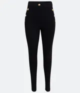 Pantalón legging negro de punto roma, con cintura alta y botones metalizados decorativos en los laterales.