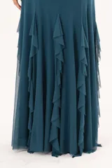 Pollera larga confeccionada en microtul color verde petroleo, totalmente forrada, de diseño fluido con volados que aportan movimiento y caída liviana.