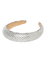 Vincha de pelo acolchada, revestida en su totalidad con pequeños cristales y strass plateados sobre base de poliéster y forro interior beige.