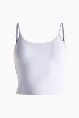 Top deportivo cropped color lila de corte ajustado, con breteles finos ajustables, escote redondo y soutien integrado con relleno extraíble. Confeccionado en tejido funcional con tecnología SoftMove y DryMove.