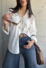 Camisa blanca de lino con detalles de encaje en los hombros y mangas 3/4.