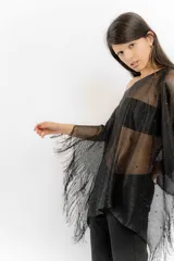 Poncho de tejido calado negro con apliques de piedras y flecos.