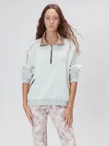 Buzo de algodón con cuello alto y cierre frontal parcial. Presenta bolsillos laterales con cierre y cuello con interior en contraste. Diseño de corte oversize.