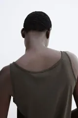 Musculosa cropped color negro, de punto suave de algodón, con corte holgado, escote en U y bajo recto.