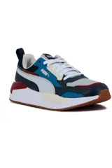 Championes deportivos Puma X-Ray en combinación de azul, gris y negro, con detalles en amarillo flúor y suela blanca y azul.
