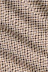 Pantalón de tiro alto con cintura elástica y piernas amplias, confeccionado en punto jacquard con diseño de cuadros pequeños.