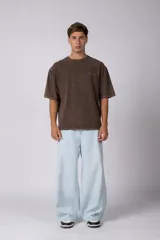 Remera de algodón gris con efecto acid wash, corte regular, mangas cortas y cuello redondo. Cuenta con un pequeño bordado tono sobre tono en el pecho y una etiqueta lateral distintiva de la marca en el ruedo.