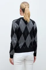 Sweater de punto con diseño de rombos en tonos negro y gris, de cuello redondo y manga larga con puños acanalados.