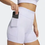 Calzas cortas de running ajustadas, color lila claro, con tiro alto, cintura elástica con cordón ajustable y bolsillos laterales.