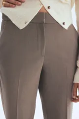 Pantalón tobillero de tejido elástico, color gris topo, con cintura estándar y elástico oculto. Presenta bolsillos al bies y bolsillos traseros decorativos.